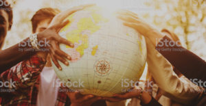 stock photo of people holding a globe